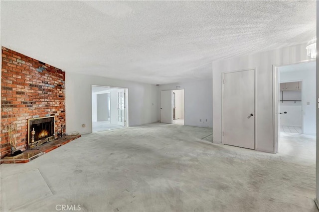 unfurnished living room featuring a textured ceiling and a fireplace