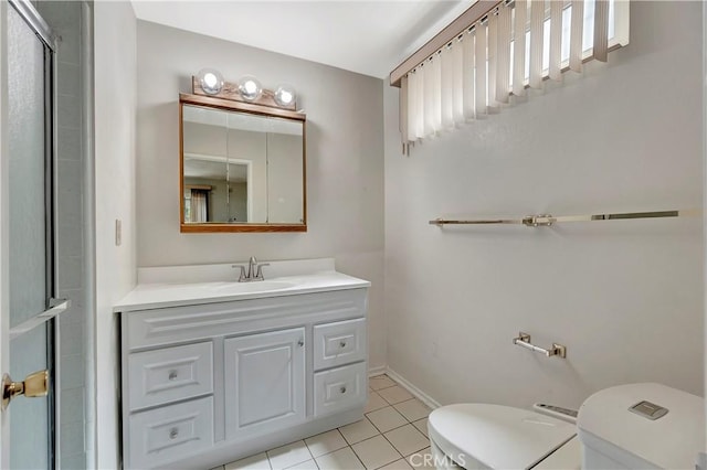 full bathroom featuring toilet, tile patterned flooring, vanity, baseboards, and an enclosed shower