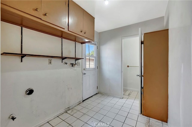 washroom with cabinet space, baseboards, light tile patterned floors, and hookup for a washing machine