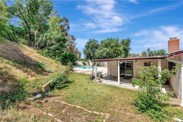 view of yard featuring an outdoor pool and a patio