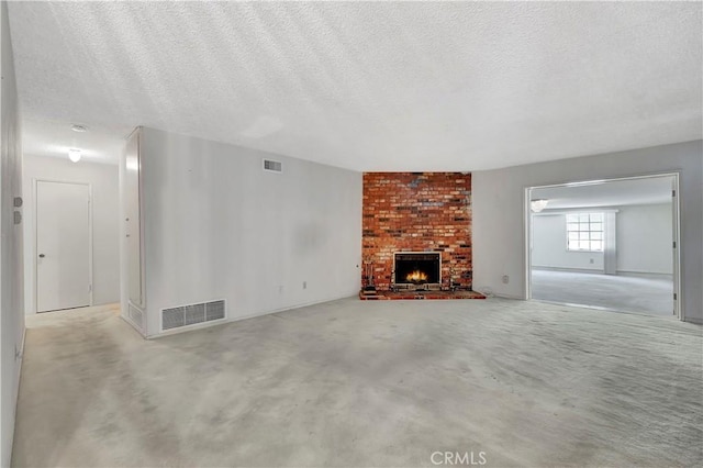 unfurnished living room with a brick fireplace and a textured ceiling