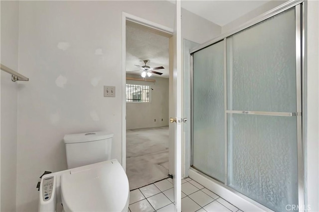 full bath with ceiling fan, a shower stall, toilet, and tile patterned flooring