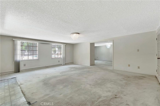 unfurnished room with a textured ceiling