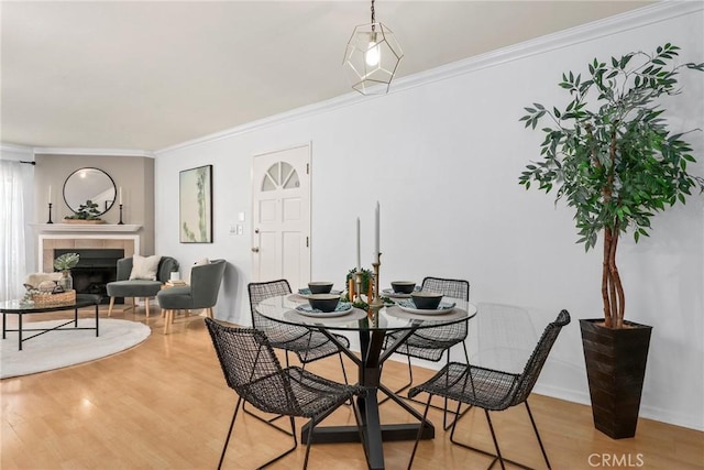 2474 S Centinela Ave Unit 4, Los Angeles, CA 90064 - dining space featuring ornamental molding, light wood-type flooring, and a tile fireplace