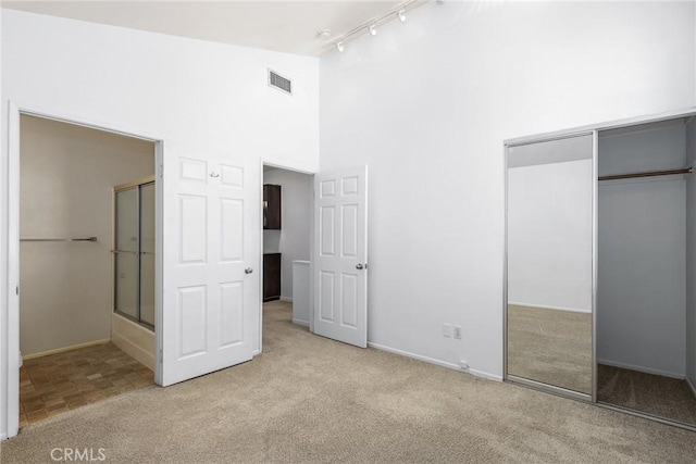 2474 S Centinela Ave Unit 4, Los Angeles, CA 90064 - unfurnished bedroom featuring track lighting, carpet, a high ceiling, a closet, and baseboards