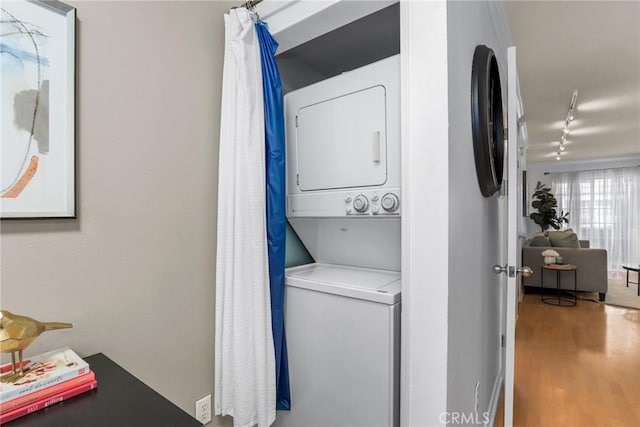 2474 S Centinela Ave Unit 4, Los Angeles, CA 90064 - laundry room with stacked washer / dryer, rail lighting, and wood finished floors