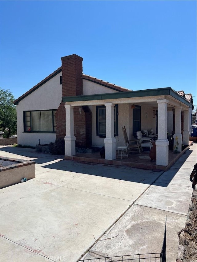 525 S L St, Needles, CA 92363 - rear view of property featuring a porch and stucco siding
