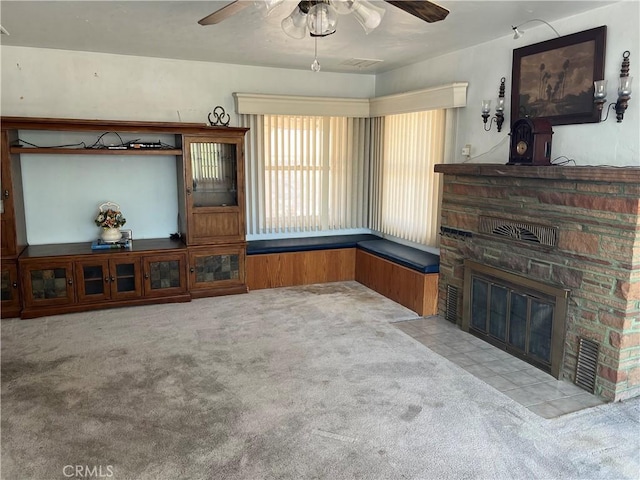 525 S L St, Needles, CA 92363 - unfurnished living room with carpet, ceiling fan, and a fireplace
