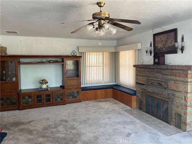 525 S L St, Needles, CA 92363 - carpeted living room featuring a ceiling fan and a fireplace with flush hearth
