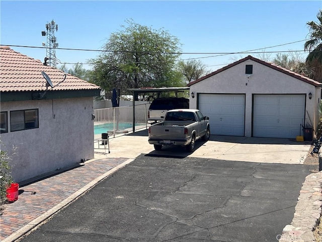 525 S L St, Needles, CA 92363 - view of home's exterior with stucco siding, a detached garage, and an outdoor structure
