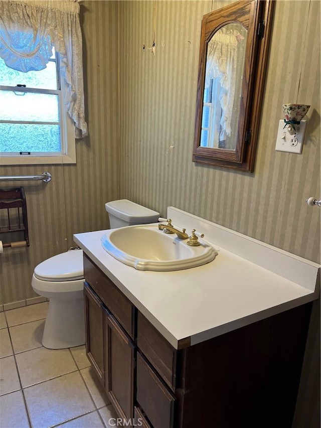 525 S L St, Needles, CA 92363 - bathroom featuring toilet, tile patterned floors, wallpapered walls, and vanity