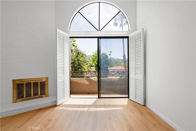 14844 Dickens St Unit 306, Sherman Oaks, CA 91403 - entryway featuring wood finished floors, a glass covered fireplace, and baseboards