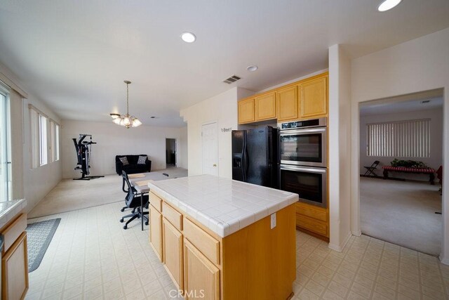 6933 Rio Grande Dr, Eastvale, CA 91752 - kitchen featuring tile countertops, double oven, light carpet, black fridge, and recessed lighting
