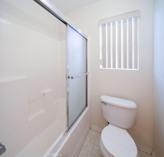 6933 Rio Grande Dr, Eastvale, CA 91752 - bathroom with toilet, shower / bath combination with glass door, and baseboards