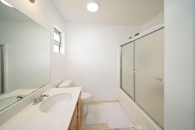 6933 Rio Grande Dr, Eastvale, CA 91752 - full bath with toilet, vanity, bath / shower combo with glass door, and baseboards