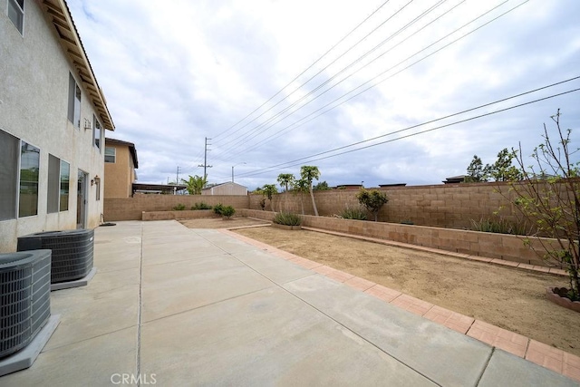 6933 Rio Grande Dr, Eastvale, CA 91752 - fenced backyard with cooling unit and a patio
