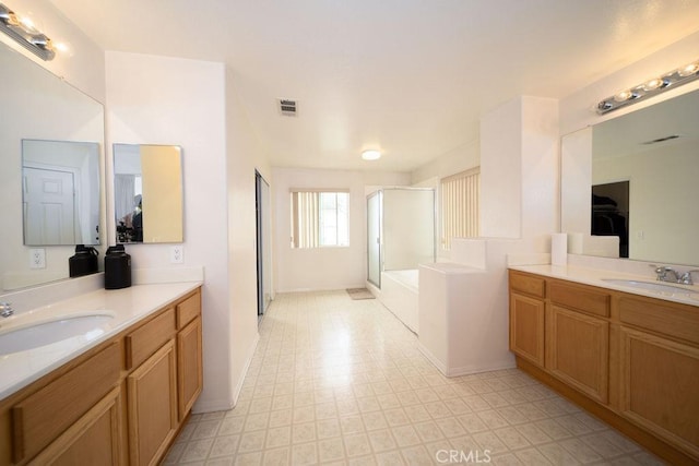 6933 Rio Grande Dr, Eastvale, CA 91752 - bathroom featuring a shower stall, tile patterned floors, two vanities, and baseboards