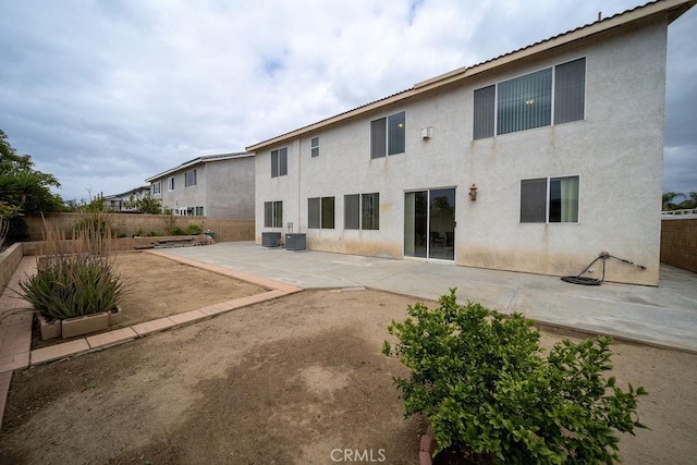 6933 Rio Grande Dr, Eastvale, CA 91752 - back of house with a patio area, stucco siding, and central AC unit