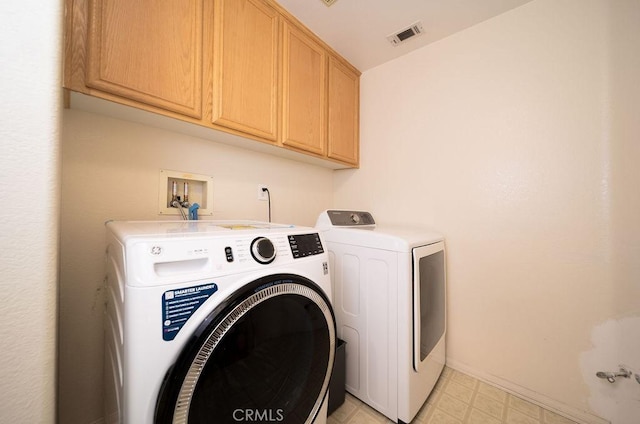 6933 Rio Grande Dr, Eastvale, CA 91752 - laundry area featuring cabinet space, separate washer and dryer, light flooring, and baseboards