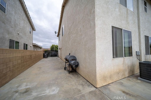 6933 Rio Grande Dr, Eastvale, CA 91752 - view of property exterior with stucco siding, a patio area, and central air condition unit