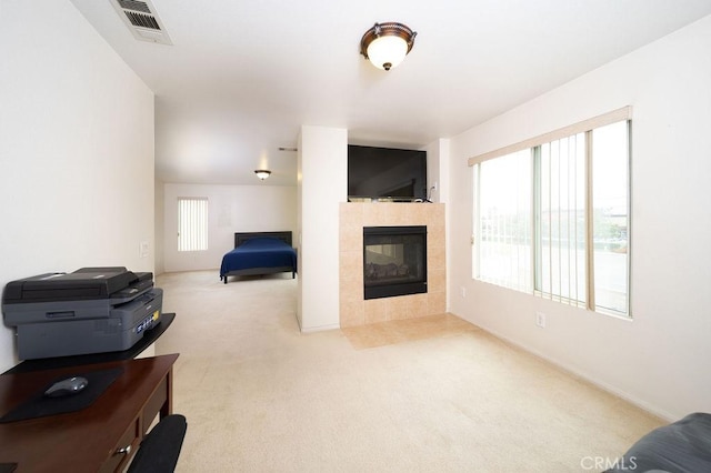 6933 Rio Grande Dr, Eastvale, CA 91752 - living area with carpet, a tiled fireplace, and baseboards