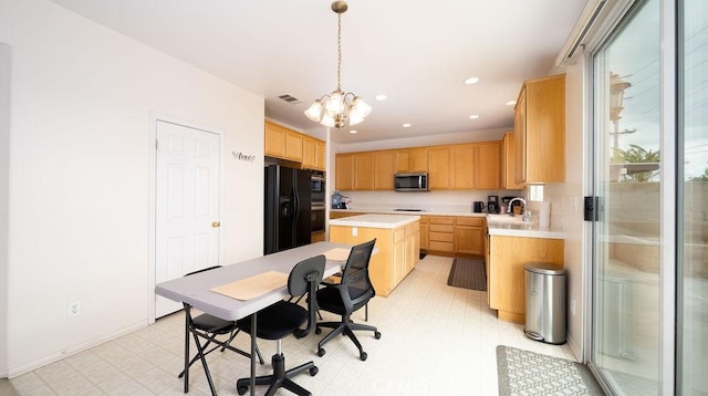 6933 Rio Grande Dr, Eastvale, CA 91752 - kitchen with black appliances, a chandelier, light countertops, a kitchen island, and an office area