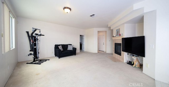 6933 Rio Grande Dr, Eastvale, CA 91752 - workout area with carpet floors and a tile fireplace
