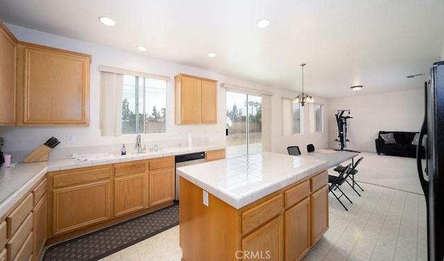 6933 Rio Grande Dr, Eastvale, CA 91752 - kitchen featuring stainless steel dishwasher, freestanding refrigerator, healthy amount of natural light, a center island, and recessed lighting