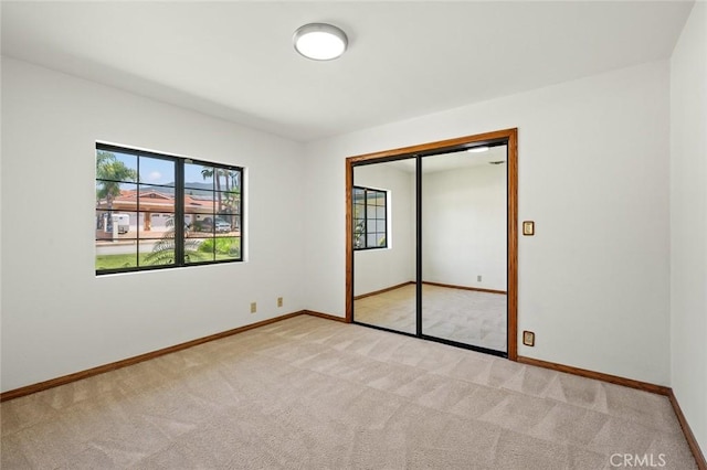 1038 E Meda Ave, Glendora, CA 91741 - unfurnished bedroom with light colored carpet, baseboards, and a closet