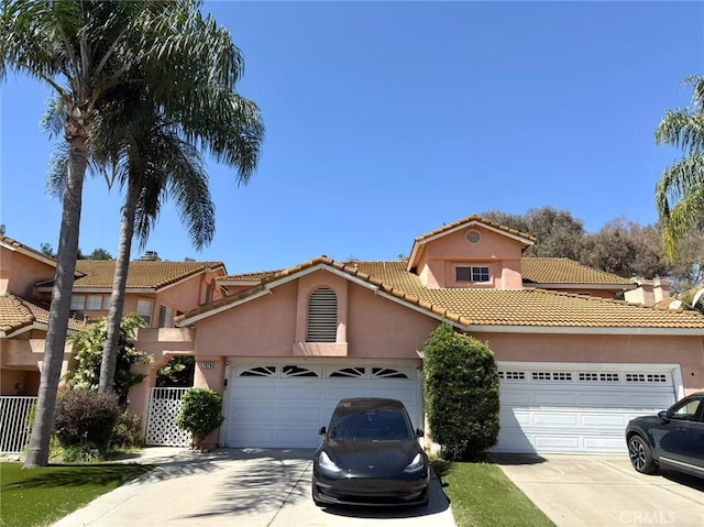 2929 Crape Myrtle Cir, Chino Hills, CA 91709 - mediterranean / spanish home with driveway, an attached garage, stucco siding, and a tile roof