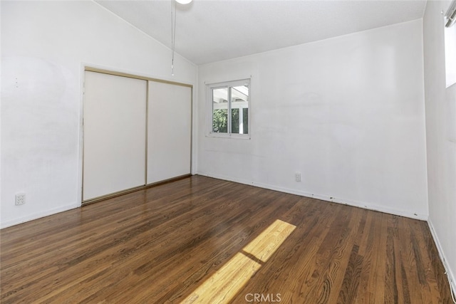 13727 Leadwell St, Van Nuys, CA 91405 - unfurnished bedroom with lofted ceiling, wood finished floors, a closet, and baseboards