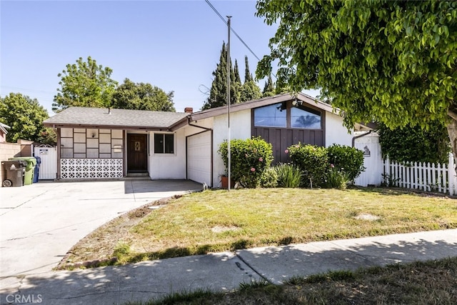 13727 Leadwell St, Van Nuys, CA 91405 - view of front facade featuring a garage, driveway, and a chimney