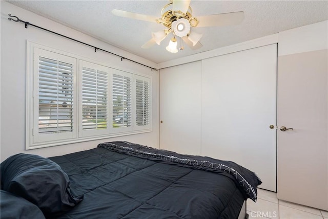 1561 W Wesley Pl, Hemet, CA 92543 - bedroom with a closet, light tile patterned flooring, a textured ceiling, and a ceiling fan