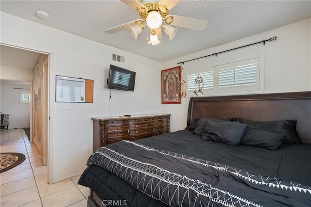 1561 W Wesley Pl, Hemet, CA 92543 - bedroom featuring light tile patterned flooring, multiple windows, a ceiling fan, and a textured ceiling