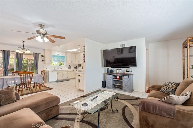 1561 W Wesley Pl, Hemet, CA 92543 - living area featuring light tile patterned floors, a ceiling fan, a chandelier, and a textured ceiling
