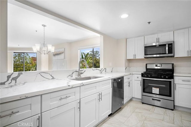 450 W Dryden St Unit 201, Glendale, CA 91202 - kitchen featuring stainless steel appliances, a sink, a chandelier, white cabinets, and light stone countertops