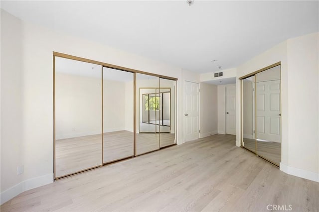 450 W Dryden St Unit 201, Glendale, CA 91202 - unfurnished bedroom with wood finished floors, two closets, and baseboards