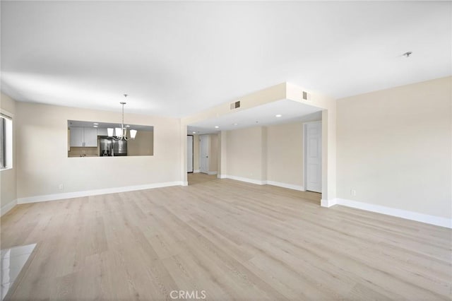 450 W Dryden St Unit 201, Glendale, CA 91202 - unfurnished living room featuring light wood-type flooring, a chandelier, and baseboards