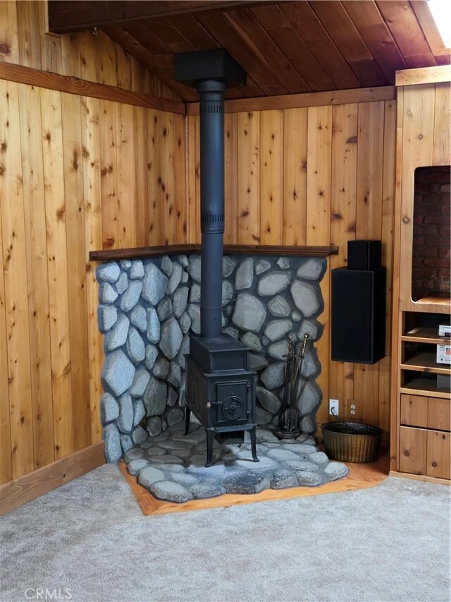 4677 Silver Saddle Ln, Paso Robles, CA 93446 - detailed view of a wood stove, carpet flooring, wood ceiling, and wooden walls