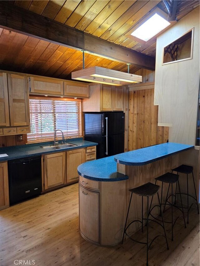 4677 Silver Saddle Ln, Paso Robles, CA 93446 - kitchen featuring black appliances, a sink, dark countertops, a peninsula, and light wood-style floors