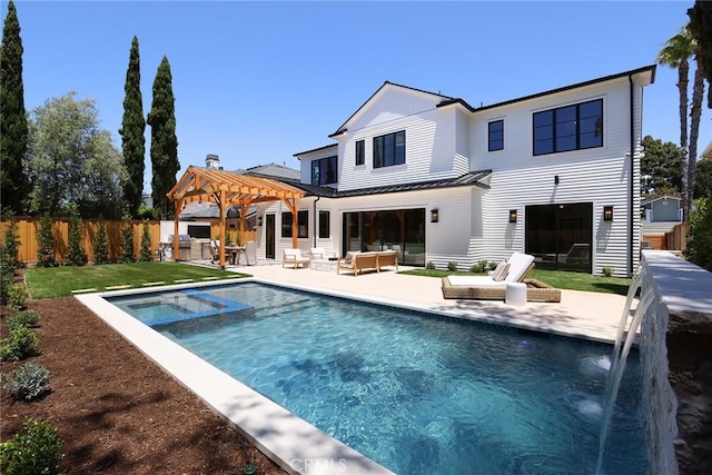 1991 Port Claridge Pl, Newport Beach, CA 92660 - rear view of house with a patio, a standing seam roof, a pool with connected hot tub, and metal roof