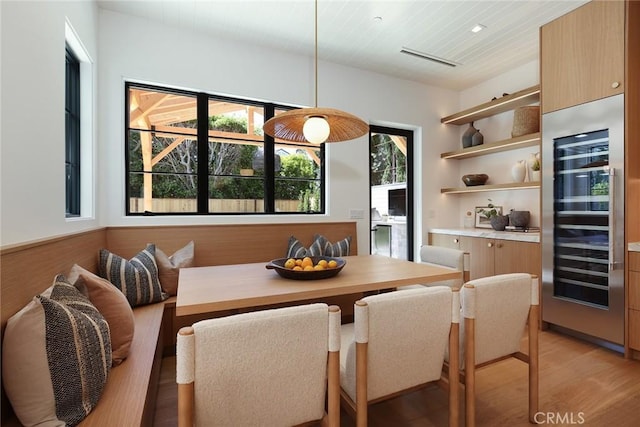 1991 Port Claridge Pl, Newport Beach, CA 92660 - dining area with wine cooler, light wood-type flooring, and healthy amount of natural light