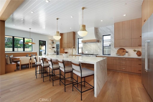 1991 Port Claridge Pl, Newport Beach, CA 92660 - kitchen with modern cabinets, custom range hood, light wood finished floors, backsplash, and recessed lighting