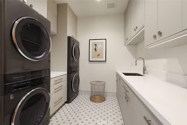 1991 Port Claridge Pl, Newport Beach, CA 92660 - washroom with stacked washer / drying machine, cabinet space, light flooring, and baseboards