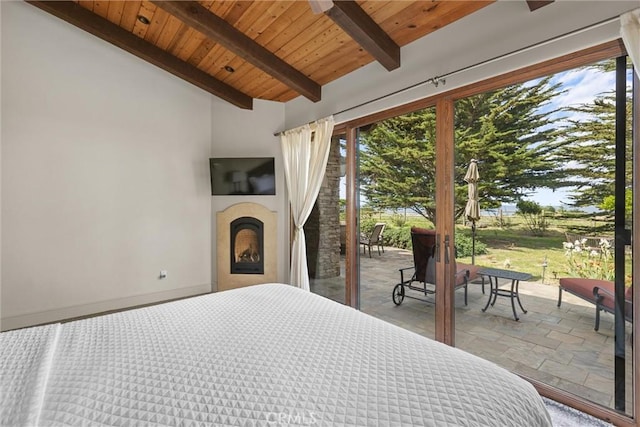 295 Via Piedras Blancas, San Simeon, CA 93452 - bedroom with stone tile flooring, wood ceiling, access to outside, and a fireplace