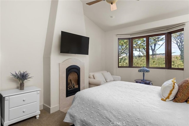 295 Via Piedras Blancas, San Simeon, CA 93452 - carpeted bedroom with lofted ceiling, a fireplace, baseboards, and ceiling fan