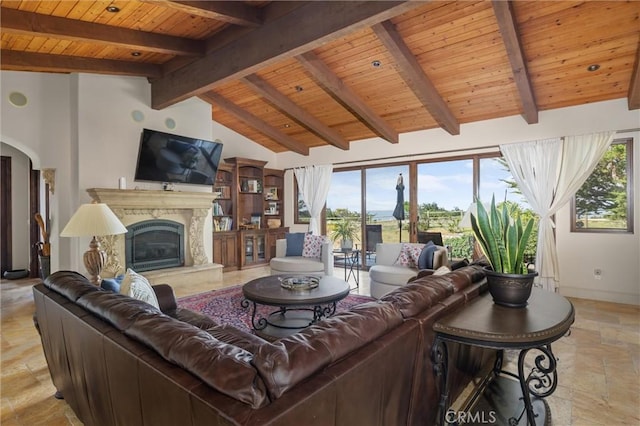 295 Via Piedras Blancas, San Simeon, CA 93452 - living area featuring wood ceiling, stone tile flooring, a high end fireplace, baseboards, and arched walkways
