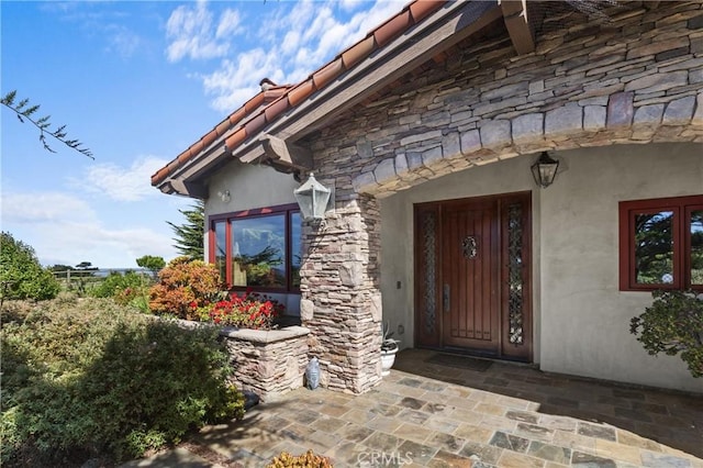 295 Via Piedras Blancas, San Simeon, CA 93452 - entrance to property with stone siding, stucco siding, and a tiled roof