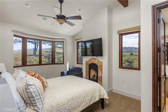 295 Via Piedras Blancas, San Simeon, CA 93452 - bedroom with vaulted ceiling, carpet flooring, a fireplace, baseboards, and ceiling fan