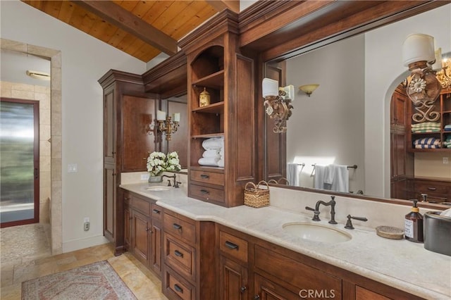 295 Via Piedras Blancas, San Simeon, CA 93452 - bathroom featuring wooden ceiling with exposed beams, double vanity, and stone finish flooring